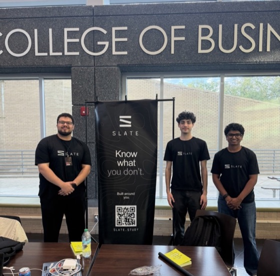 The three Slate co-founders standing at a Slate booth in the USF College of Business